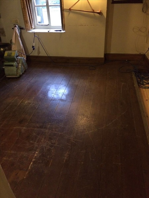 The dark floor before sanding